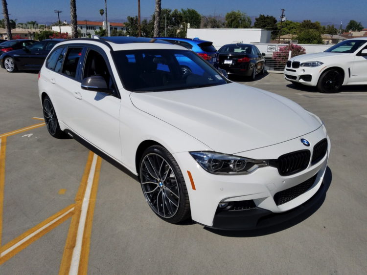 BMW 328d Sports Wagon in white exterior, featuring sleek design and sporty details.