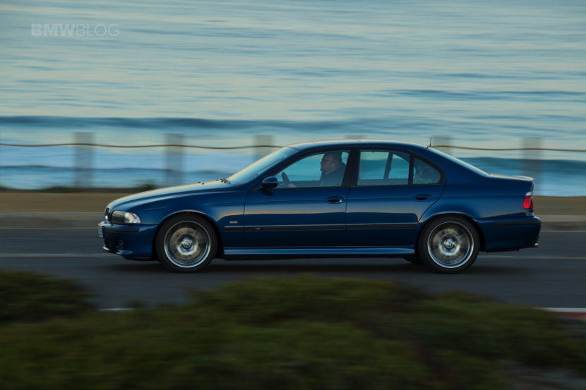 E39 BMW M5 driving on a coast road