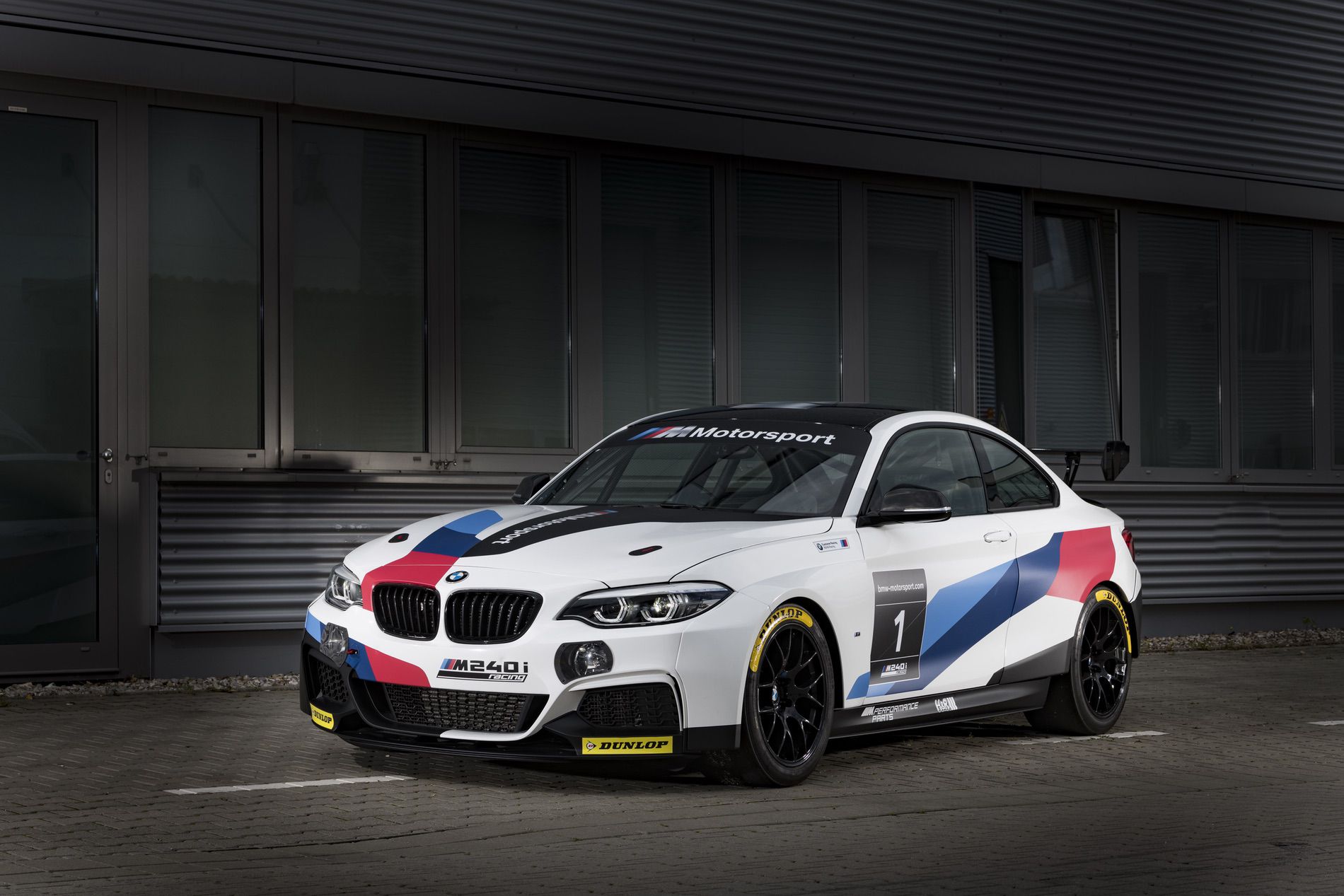 BMW M240i Racing Evo with new rear wing and motorsport livery at the racetrack
