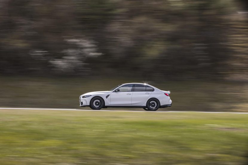 Alpine white G80 BMW M3 side view driving