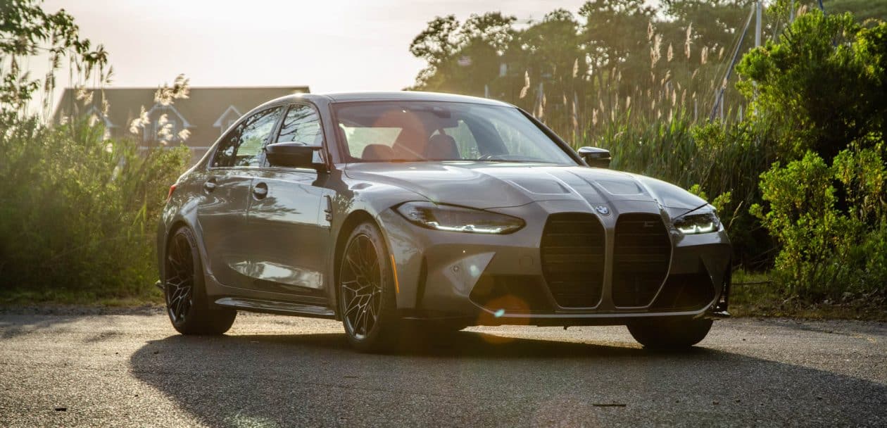 2021 BMW M3 Competition in Oxide Grey Metallic parked in a forrest