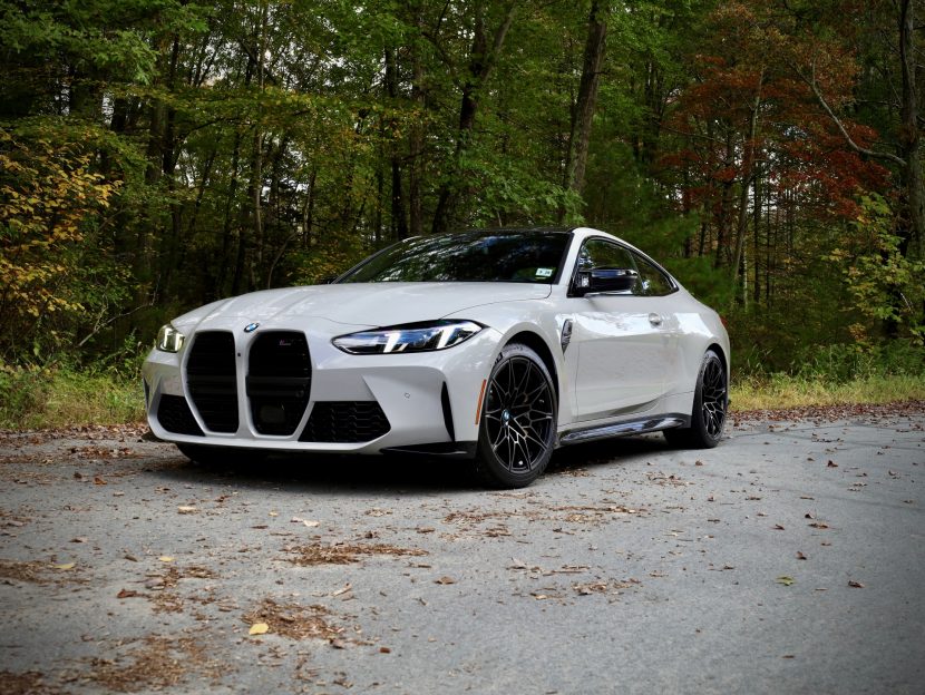 BMW M4 Competition in Chalk gray from front-side angle, parked outdoors