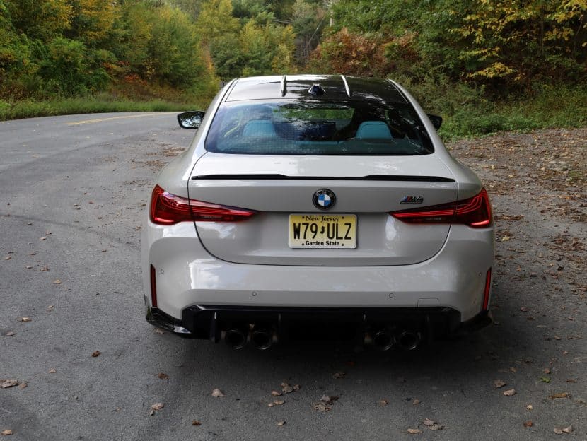 Rear angle of the 2025 BMW M4 showing new LED taillights and quad exhaust