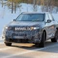 Camouflaged 2027 BMW X5 G65 prototype testing on Autobahn with Vision Neue Klasse–style hidden door handles