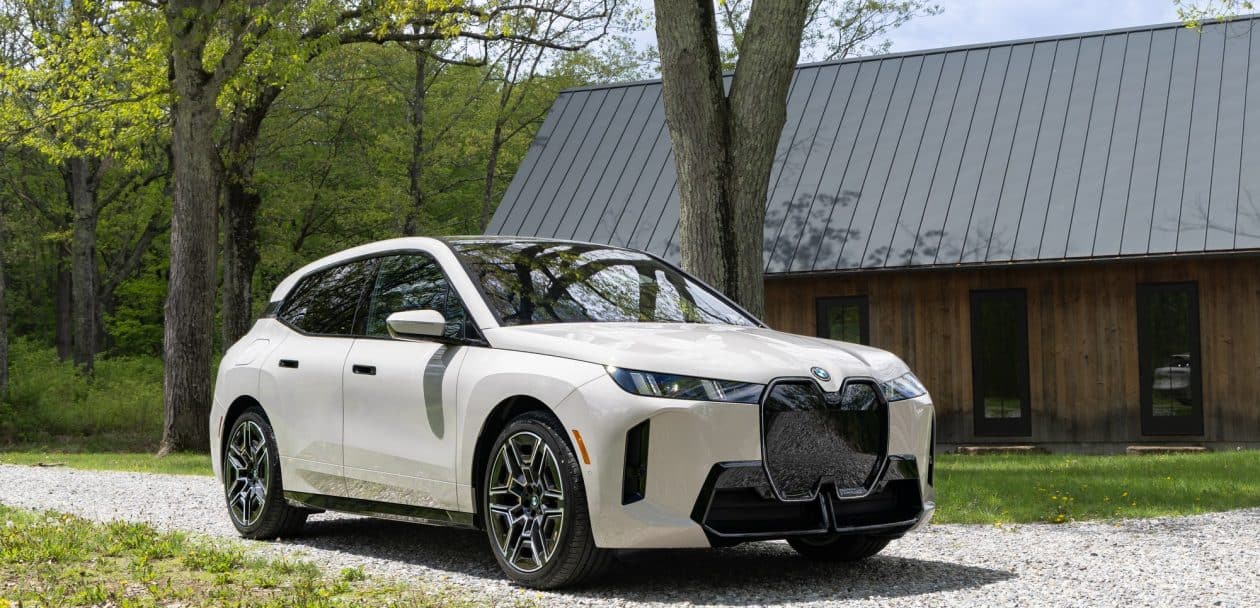 2026 BMW iX xDrive45 front three-quarter view with 21-inch wheels