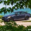 2025 BMW M5 G90 in Sepia Metallic parked by the lake