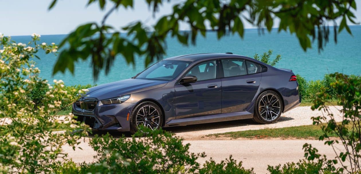 2025 BMW M5 G90 in Sepia Metallic parked by the lake
