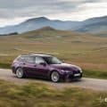 BMW M3 Touring Competition in Twilight Purple driving through Romanian mountain roads