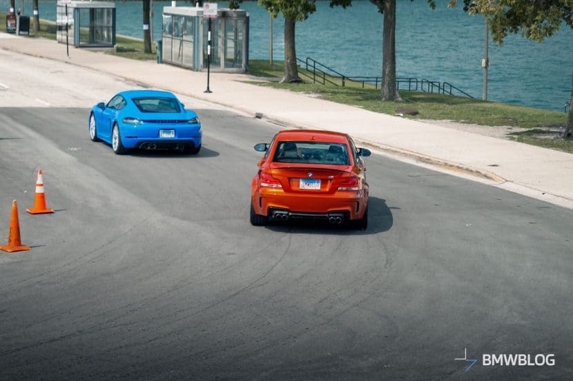 BMW 1M VS PORSCHE CAYMAN GTS DRIVING BY THE LAKE