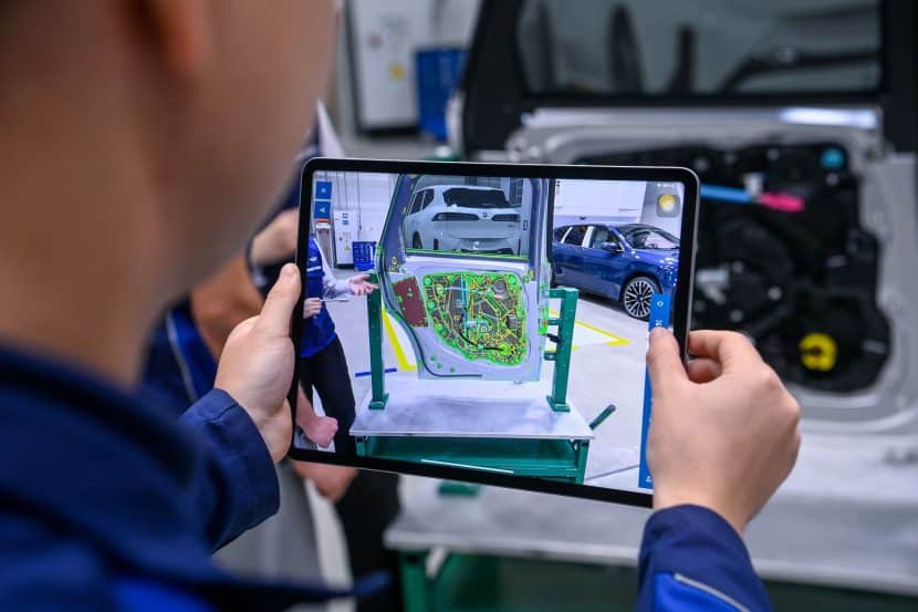 BMW PLANT DEBRECEN employee using an iPad to check quality