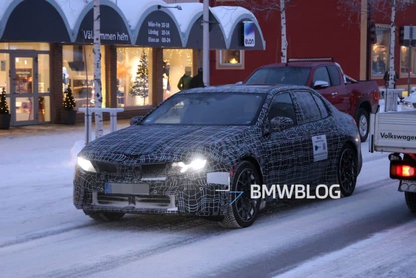 2026 BMW I3 ELECTRIC SEDAN WINTER TESTING 09 Prototype of the 2026 BMW i3 Sedan testing in winter conditions near Arjeplog with production headlights visible.